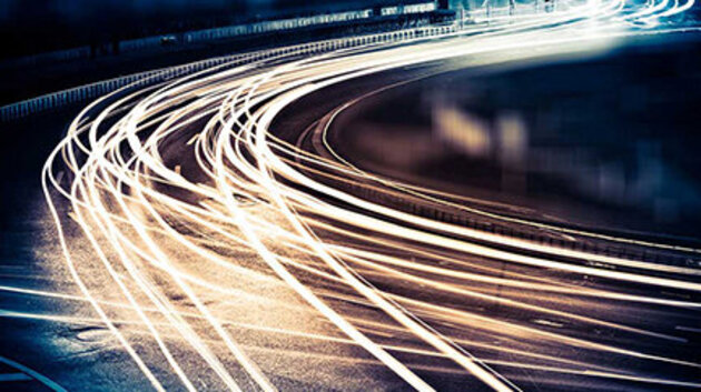 Smeared car headlights on a freeway by night